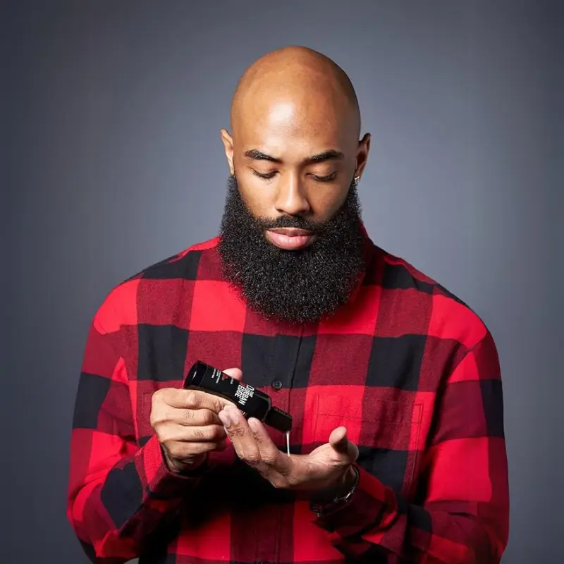 Black man using that urban edge beard shampoo