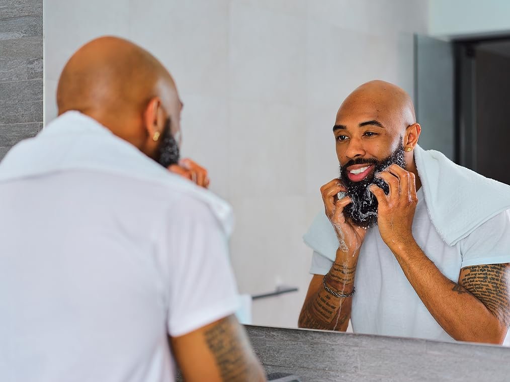 Model looking at the mirror after using beard shamnpoo